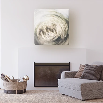 a room with a fireplace and armchair with an abstract green picture on the wall