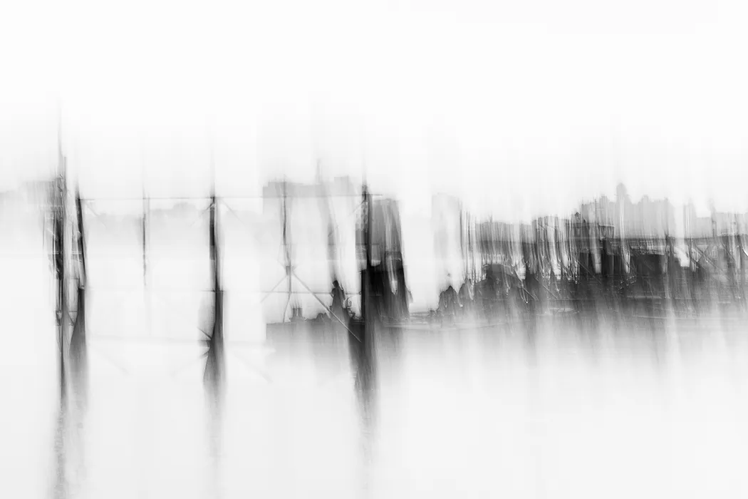 Poles in the water in front of industrial buildings and ferry jetties are reflected in Kolkata – ICM Photography Kolkata: Veils of Light by Marion Rockstroh-Kruft