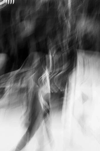 A young man walks towards a glimmer of light in the streets of Kolkata – ICM Photography Kolkata: Veils of Light by Marion Rockstroh-Kruft
